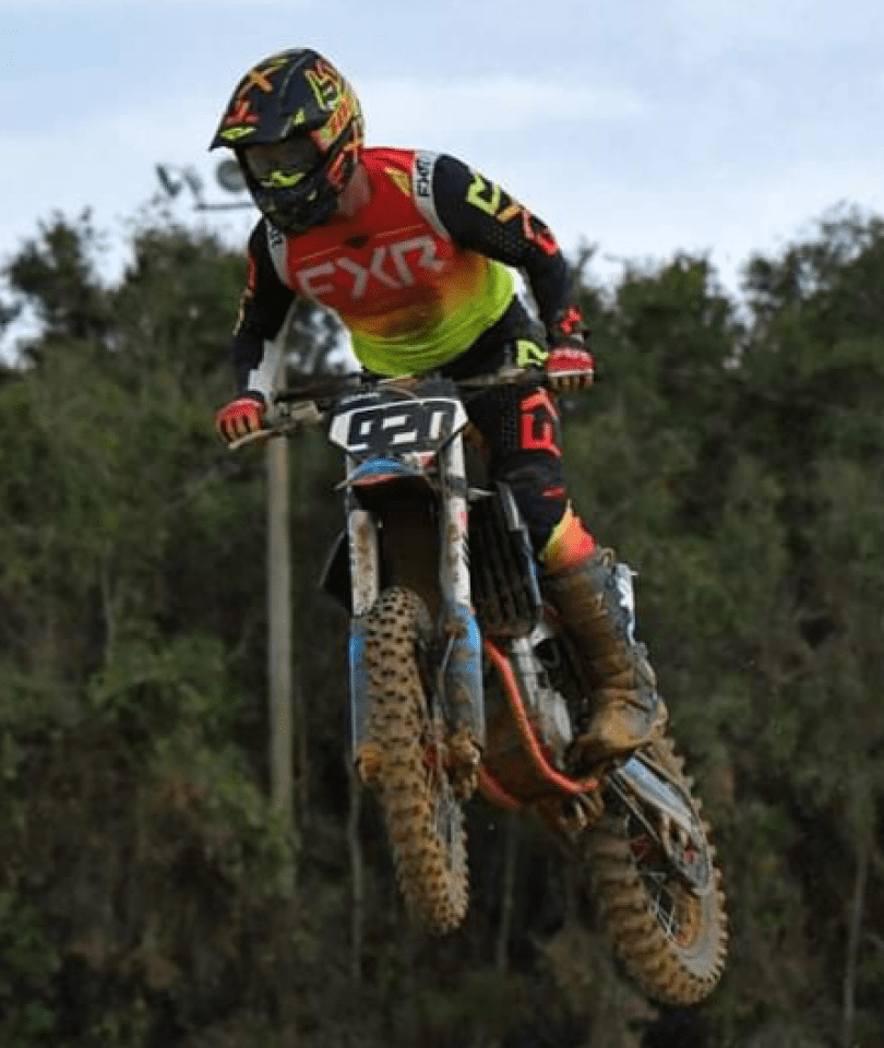 A man riding on the back of a dirt bike.