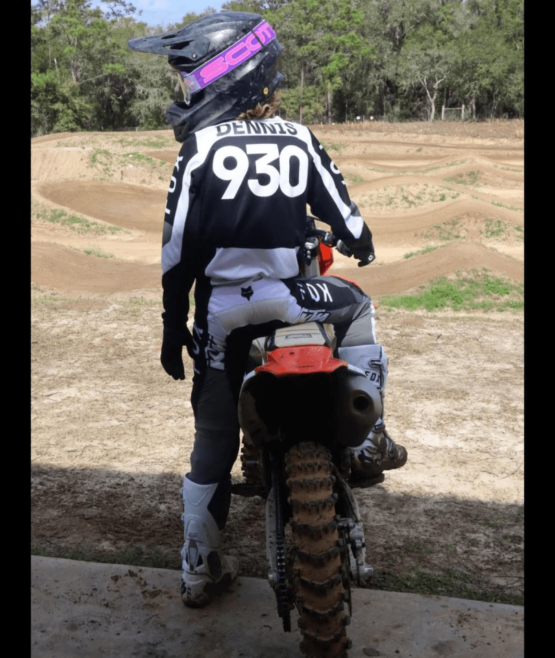 A person on a dirt bike in the dirt.