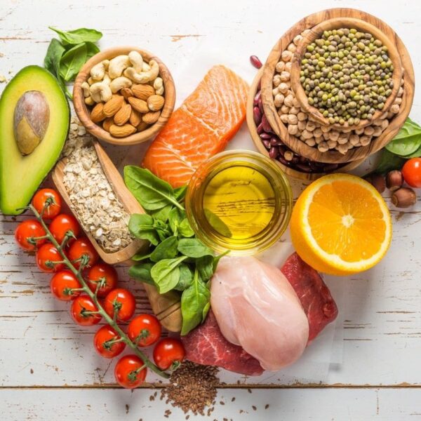 A heart shaped table with various foods on it.